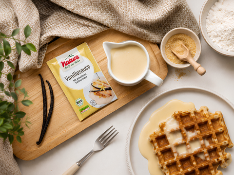 Cremige vegane Vanillesauce in einer Schüssel, serviert als Dessertsoße zu frischen Beeren und Gebäck.